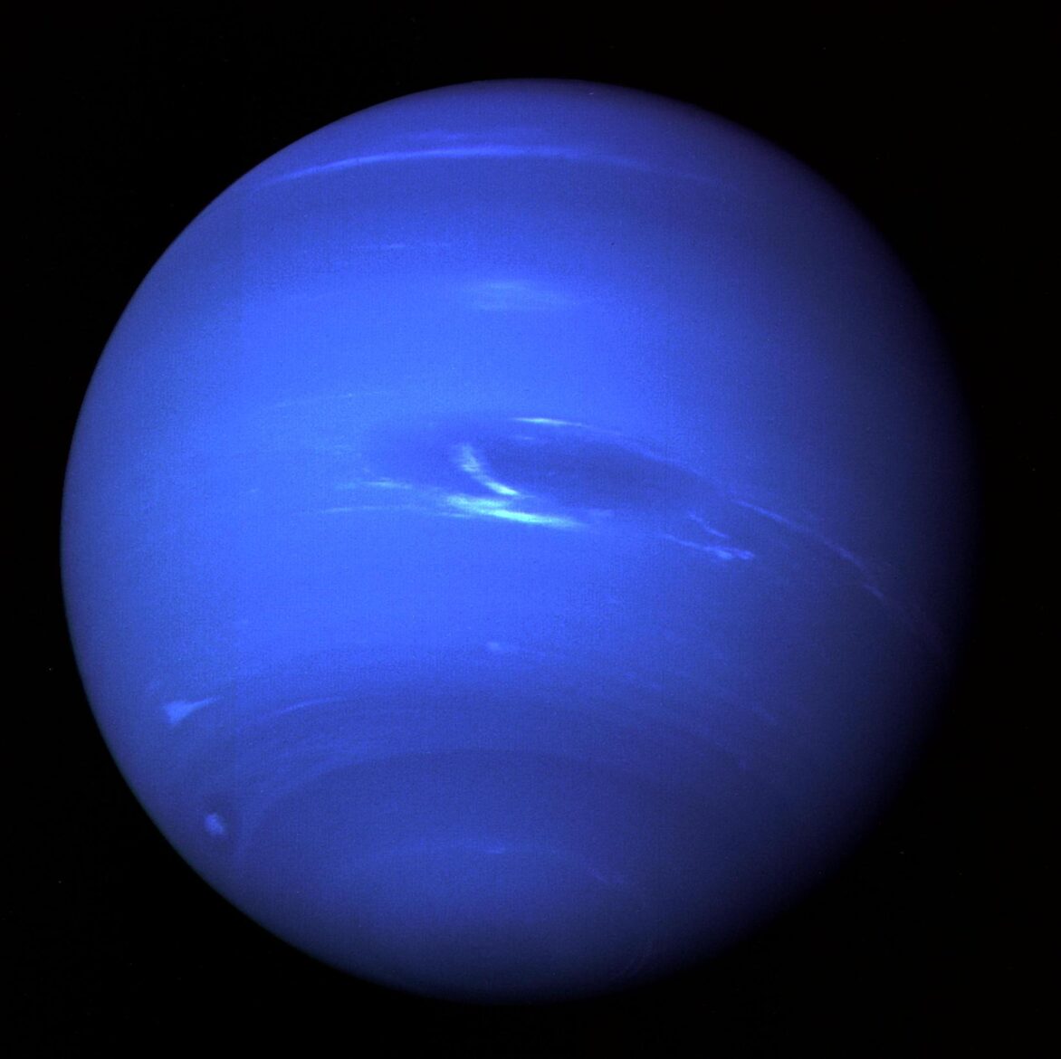 This picture of Neptune was produced from the last whole planet images taken through the green and orange filters on NASA's Voyager 2 narrow angle camera. The images were taken at a range of 4.4 million miles from the planet, 4 days and 20 hours before closest approach. The picture shows the Great Dark Spot and its companion bright smudge; on the west limb the fast moving bright feature called Scooter and the little dark spot are visible. These clouds were seen to persist for as long as Voyager's cameras could resolve them. North of these, a bright cloud band similar to the south polar streak may be seen.